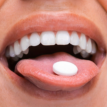 Close-up of a person with a white tablet on tongue, showcasing Teeth Whitening Pap+ Fizz for a bright smile.