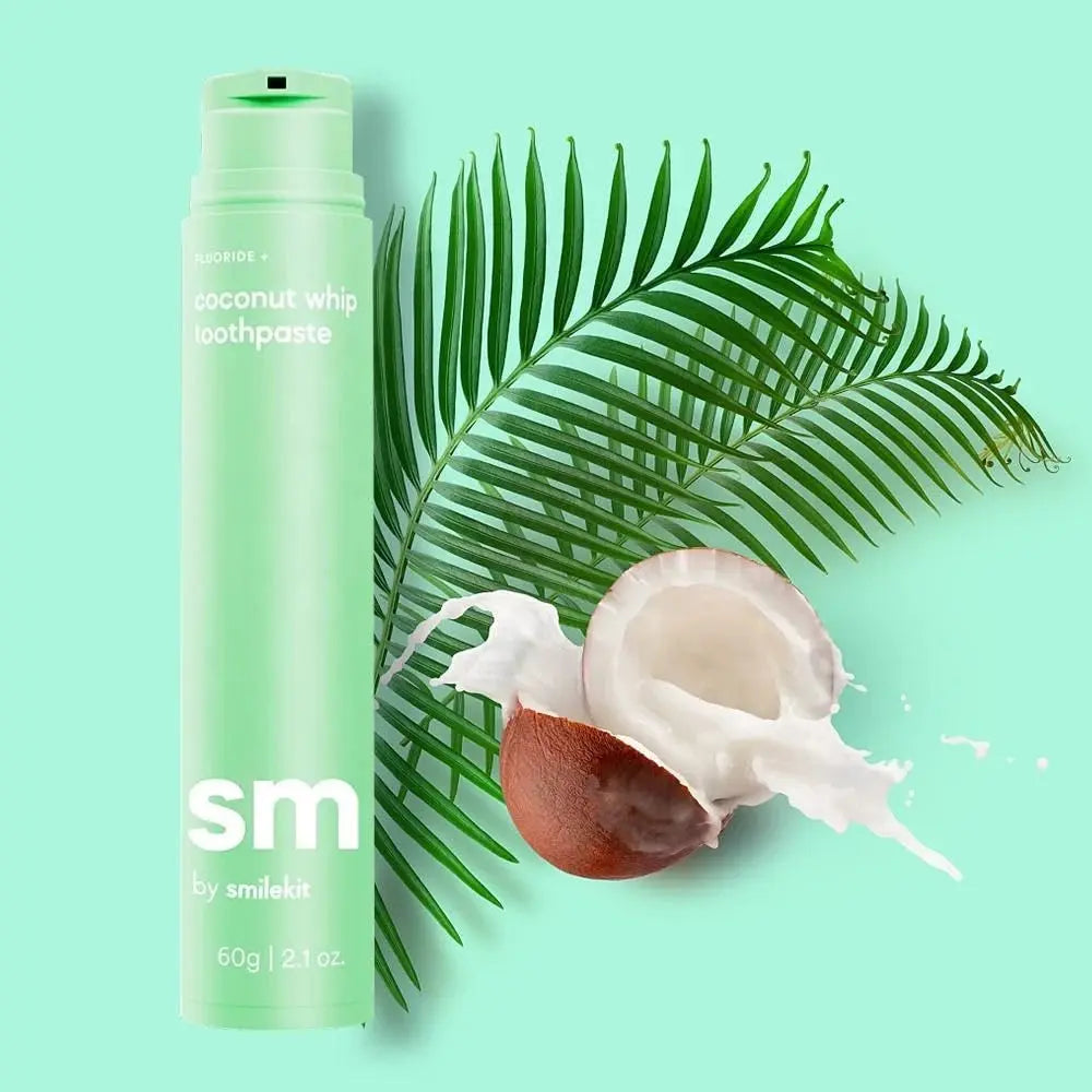 Coconut flavored toothpaste by Smilekit with palm leaf and coconut background.