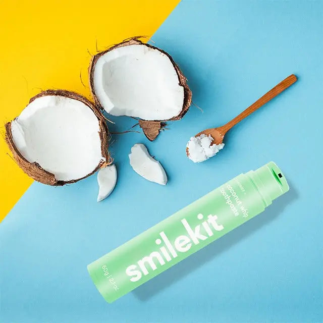 Smilekit toothpaste with coconut flavor on a colorful background