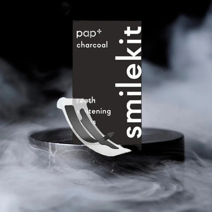 PAP+ Charcoal Whitening Strips packaging with smoke background.