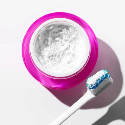 PAP+ Whitening Powder in a pink container with a toothbrush.