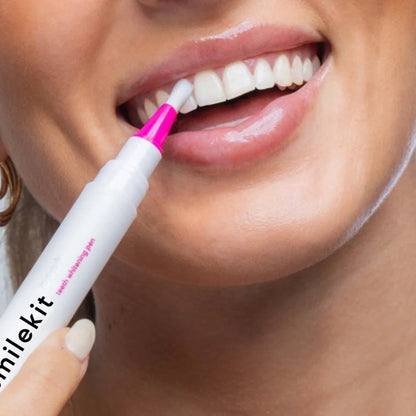 Woman using PAP+ Whitening Pen on teeth for a brighter smile.